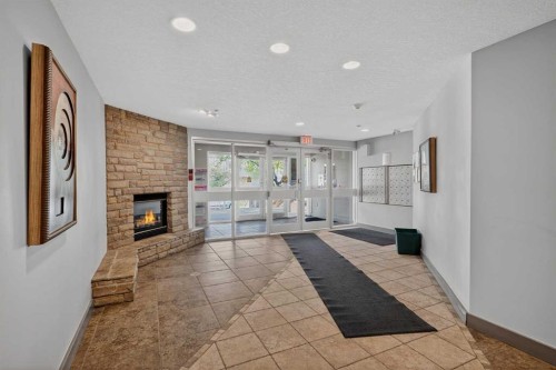 116-790 Kingsmere Crescent Sw, Calgary, AB - Indoor Photo Showing Other Room With Fireplace