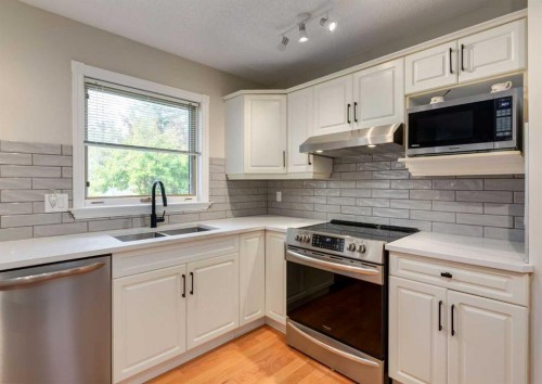 63 Arbour Lake Drive Nw, Calgary, AB - Indoor Photo Showing Kitchen With Stainless Steel Kitchen With Double Sink With Upgraded Kitchen