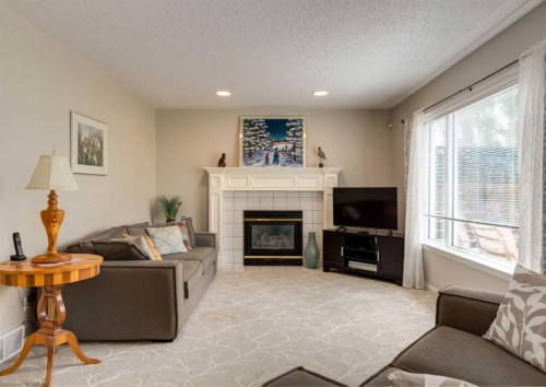 63 Arbour Lake Drive Nw, Calgary, AB - Indoor Photo Showing Living Room With Fireplace