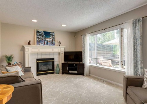 63 Arbour Lake Drive Nw, Calgary, AB - Indoor Photo Showing Living Room With Fireplace