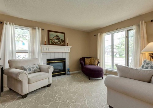 63 Arbour Lake Drive Nw, Calgary, AB - Indoor Photo Showing Living Room With Fireplace