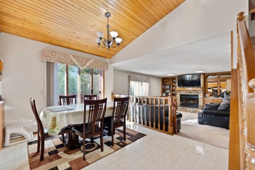 48 Castleglen Court Ne, Calgary, AB - Indoor Photo Showing Dining Room With Fireplace