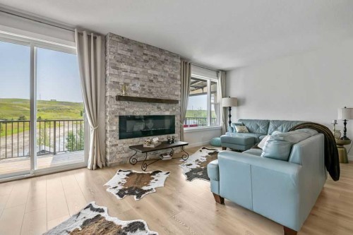 100 Cranbrook Gardens West, Calgary, AB - Indoor Photo Showing Living Room With Fireplace