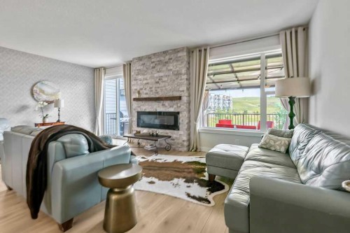 100 Cranbrook Gardens West, Calgary, AB - Indoor Photo Showing Living Room With Fireplace