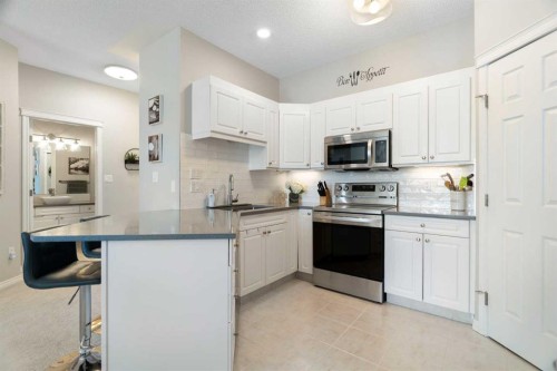1301-7451 Springbank Boulevard Sw, Calgary, AB - Indoor Photo Showing Kitchen With Double Sink With Upgraded Kitchen