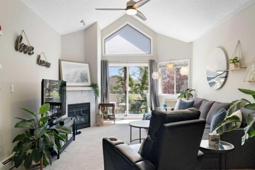 1301-7451 Springbank Boulevard Sw, Calgary, AB - Indoor Photo Showing Living Room With Fireplace