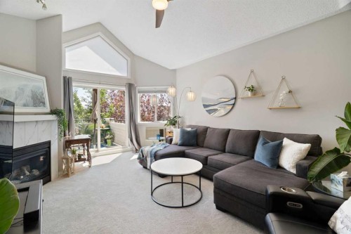 1301-7451 Springbank Boulevard Sw, Calgary, AB - Indoor Photo Showing Living Room With Fireplace
