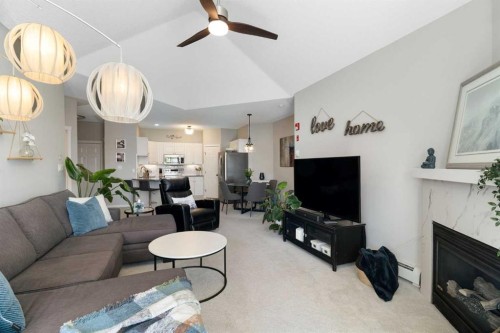 1301-7451 Springbank Boulevard Sw, Calgary, AB - Indoor Photo Showing Living Room With Fireplace