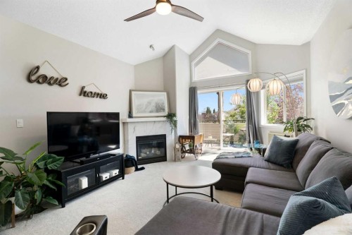 1301-7451 Springbank Boulevard Sw, Calgary, AB - Indoor Photo Showing Living Room With Fireplace