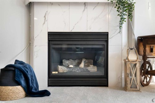 1301-7451 Springbank Boulevard Sw, Calgary, AB - Indoor Photo Showing Living Room With Fireplace