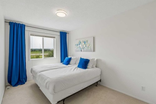 74 Spring View Sw, Calgary, AB - Indoor Photo Showing Bedroom