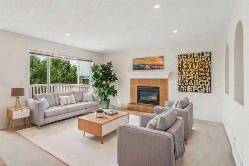 74 Spring View Sw, Calgary, AB - Indoor Photo Showing Living Room With Fireplace
