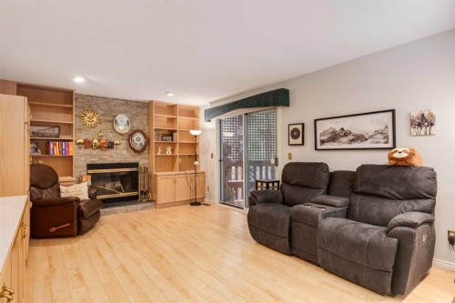 660 Coach Grove Road Sw, Calgary, AB - Indoor Photo Showing Living Room With Fireplace