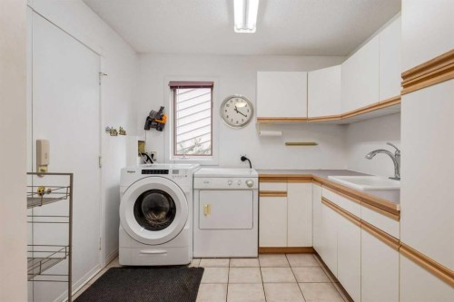 660 Coach Grove Road Sw, Calgary, AB - Indoor Photo Showing Laundry Room