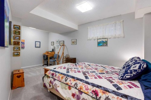 660 Coach Grove Road Sw, Calgary, AB - Indoor Photo Showing Bedroom