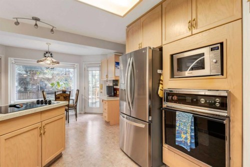 660 Coach Grove Road Sw, Calgary, AB - Indoor Photo Showing Kitchen With Stainless Steel Kitchen