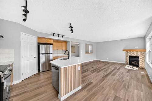 94 Panamount Rise Nw, Calgary, AB - Indoor Photo Showing Kitchen With Fireplace
