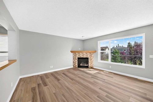 94 Panamount Rise Nw, Calgary, AB - Indoor Photo Showing Living Room With Fireplace