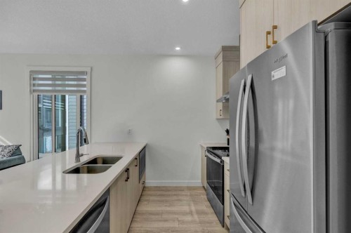 152-380 Seton Villas Se, Calgary, AB - Indoor Photo Showing Kitchen With Stainless Steel Kitchen With Double Sink With Upgraded Kitchen