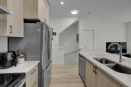 152-380 Seton Villas Se, Calgary, AB - Indoor Photo Showing Kitchen With Stainless Steel Kitchen With Double Sink