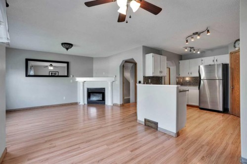158 Saratoga Close Ne, Calgary, AB - Indoor Photo Showing Kitchen With Fireplace