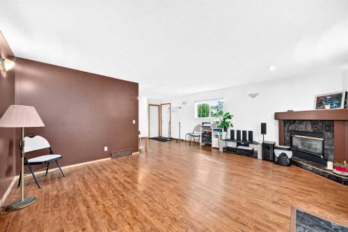 98 Country Hills Heights Nw, Calgary, AB - Indoor Photo Showing Living Room With Fireplace