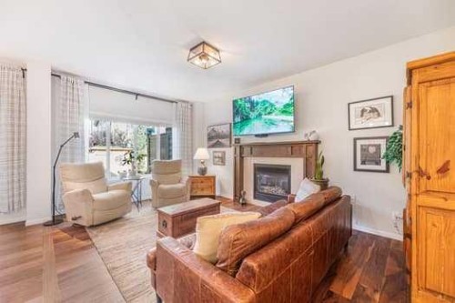 204 Paint Horse Drive, Cochrane, AB - Indoor Photo Showing Living Room With Fireplace