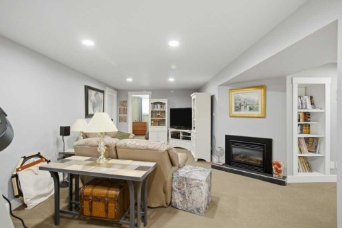 736 Canfield Place Sw, Calgary, AB - Indoor Photo Showing Living Room With Fireplace