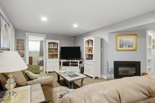 736 Canfield Place Sw, Calgary, AB - Indoor Photo Showing Living Room With Fireplace