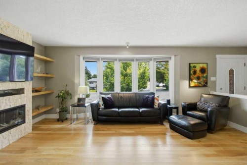 736 Canfield Place Sw, Calgary, AB - Indoor Photo Showing Living Room With Fireplace