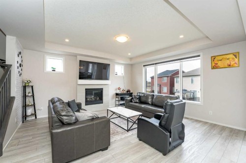 717 Windrow Manor Sw, Airdrie, AB - Indoor Photo Showing Living Room With Fireplace