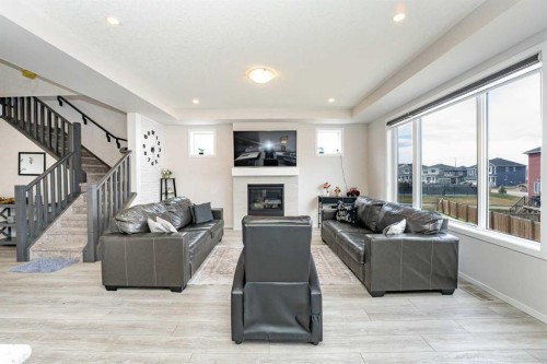 717 Windrow Manor Sw, Airdrie, AB - Indoor Photo Showing Living Room With Fireplace