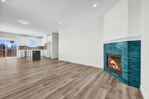 127 Westview Drive, Nanton, AB - Indoor Photo Showing Living Room With Fireplace