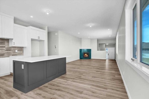 127 Westview Drive, Nanton, AB - Indoor Photo Showing Kitchen With Fireplace