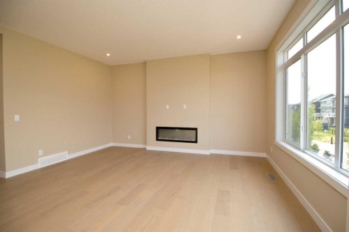 127 Sundown Crescent, Cochrane, AB - Indoor Photo Showing Other Room With Fireplace