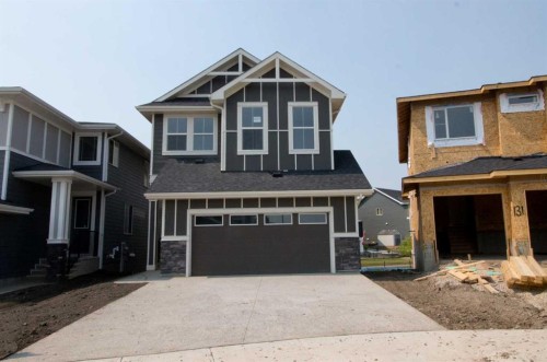 127 Sundown Crescent, Cochrane, AB - Outdoor With Facade