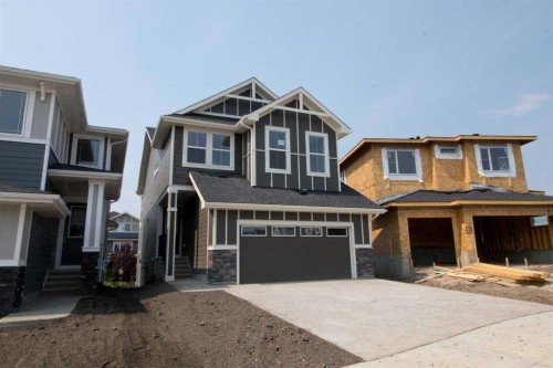 127 Sundown Crescent, Cochrane, AB - Outdoor With Facade