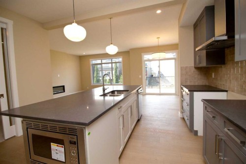 127 Sundown Crescent, Cochrane, AB - Indoor Photo Showing Kitchen With Double Sink