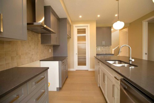 127 Sundown Crescent, Cochrane, AB - Indoor Photo Showing Kitchen With Double Sink With Upgraded Kitchen