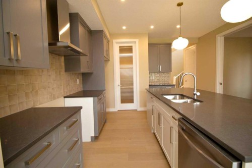 127 Sundown Crescent, Cochrane, AB - Indoor Photo Showing Kitchen With Double Sink
