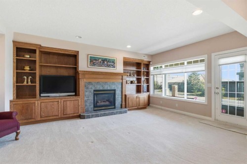 60 Prominence Point Sw, Calgary, AB - Indoor Photo Showing Living Room With Fireplace