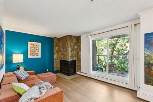 404-354 2 Avenue Ne, Calgary, AB - Indoor Photo Showing Living Room With Fireplace