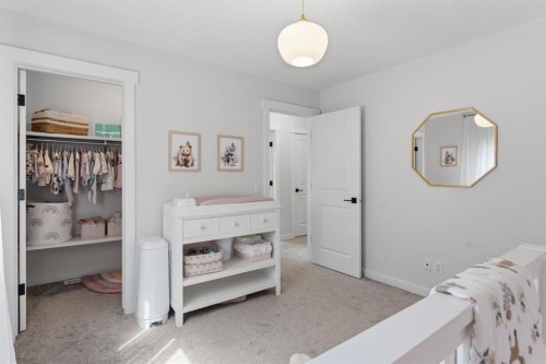 708 Coopers Square Sw, Airdrie, AB - Indoor Photo Showing Bedroom