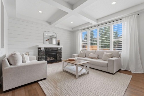 708 Coopers Square Sw, Airdrie, AB - Indoor Photo Showing Living Room With Fireplace