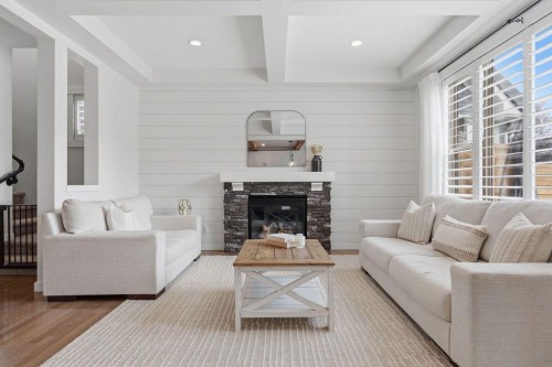 708 Coopers Square Sw, Airdrie, AB - Indoor Photo Showing Living Room With Fireplace