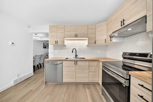 135 Woodsman Lane Sw, Calgary, AB - Indoor Photo Showing Kitchen With Double Sink