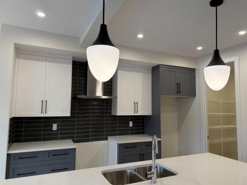 111 Sundown Crescent, Cochrane, AB - Indoor Photo Showing Kitchen With Double Sink