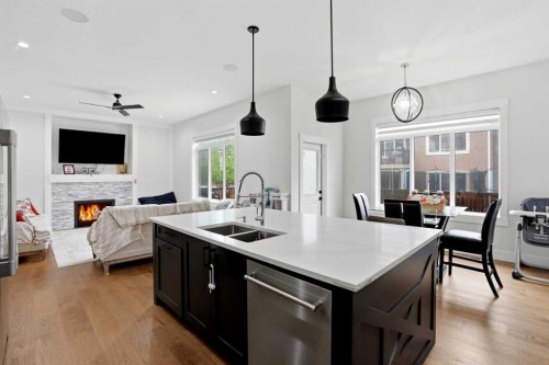 166 Kinniburgh Crescent, Chestermere, AB - Indoor Photo Showing Kitchen With Fireplace With Double Sink
