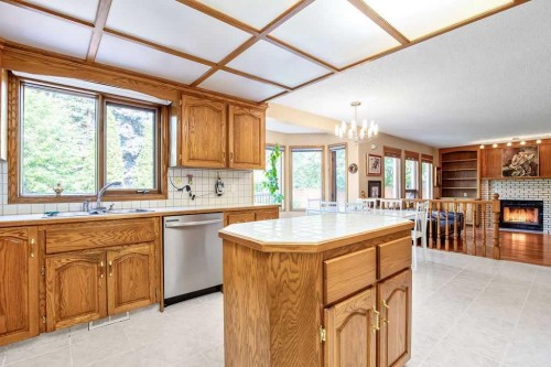 208 Hawkview Manor Place Nw, Calgary, AB - Indoor Photo Showing Kitchen With Fireplace With Double Sink