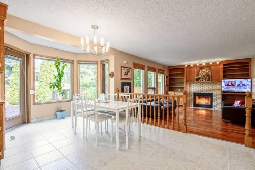 208 Hawkview Manor Place Nw, Calgary, AB - Indoor Photo Showing Dining Room With Fireplace